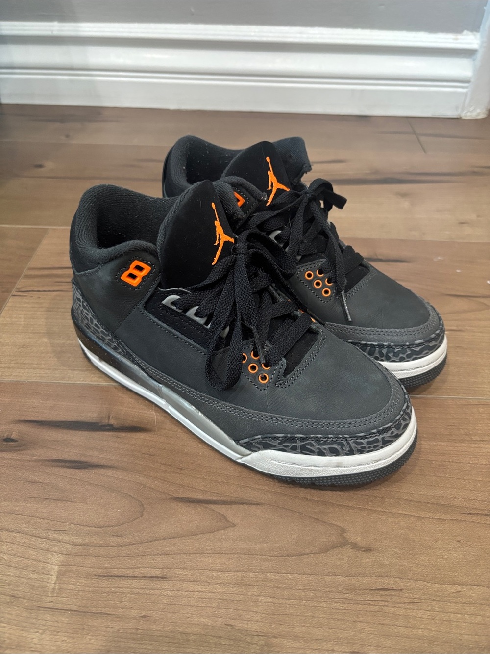 Jordan’s Black and Orange Low-Top Sneakers women’s 6/ youth 4.5
